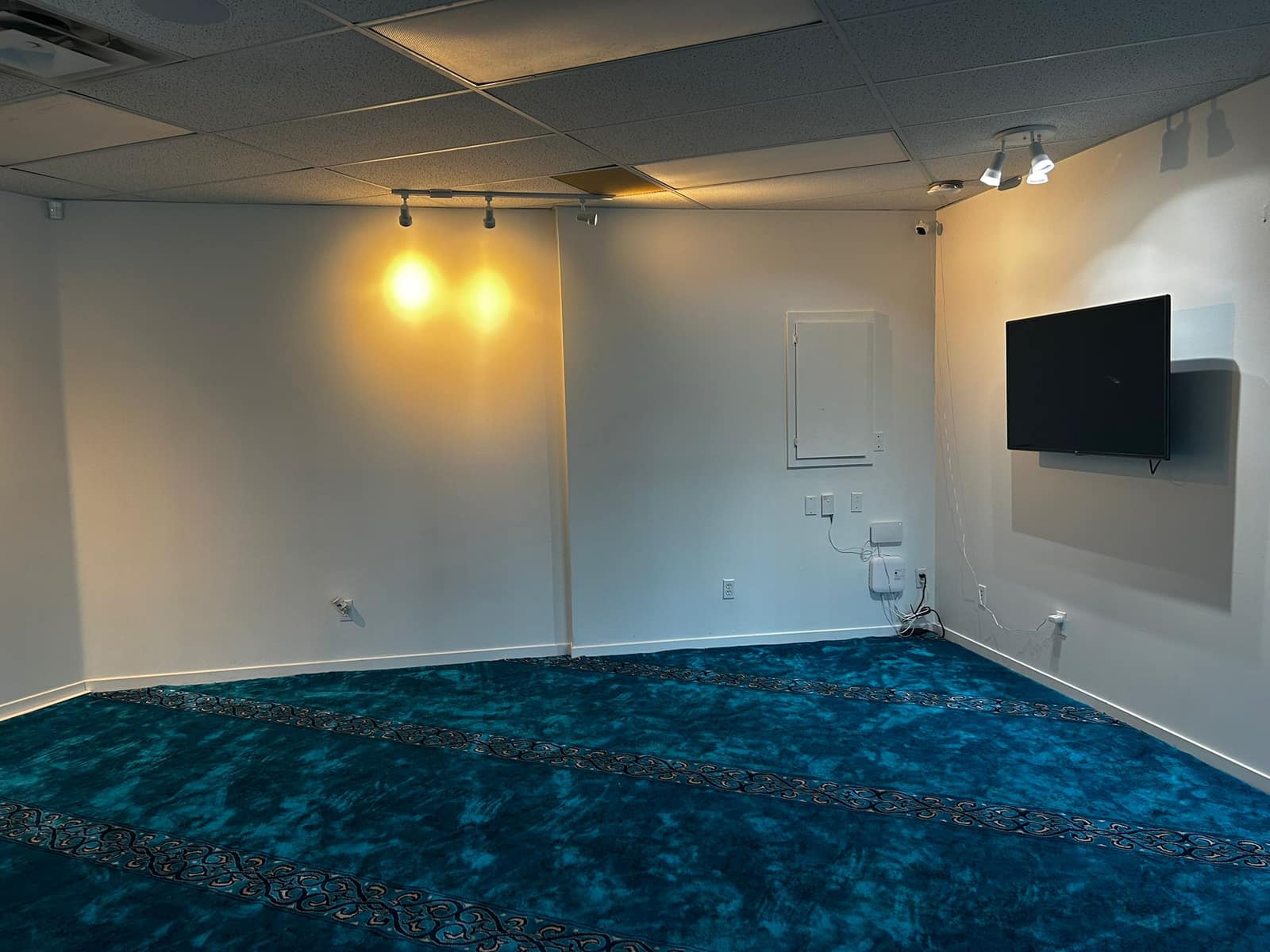 Prayer hall under warm ceiling lighting