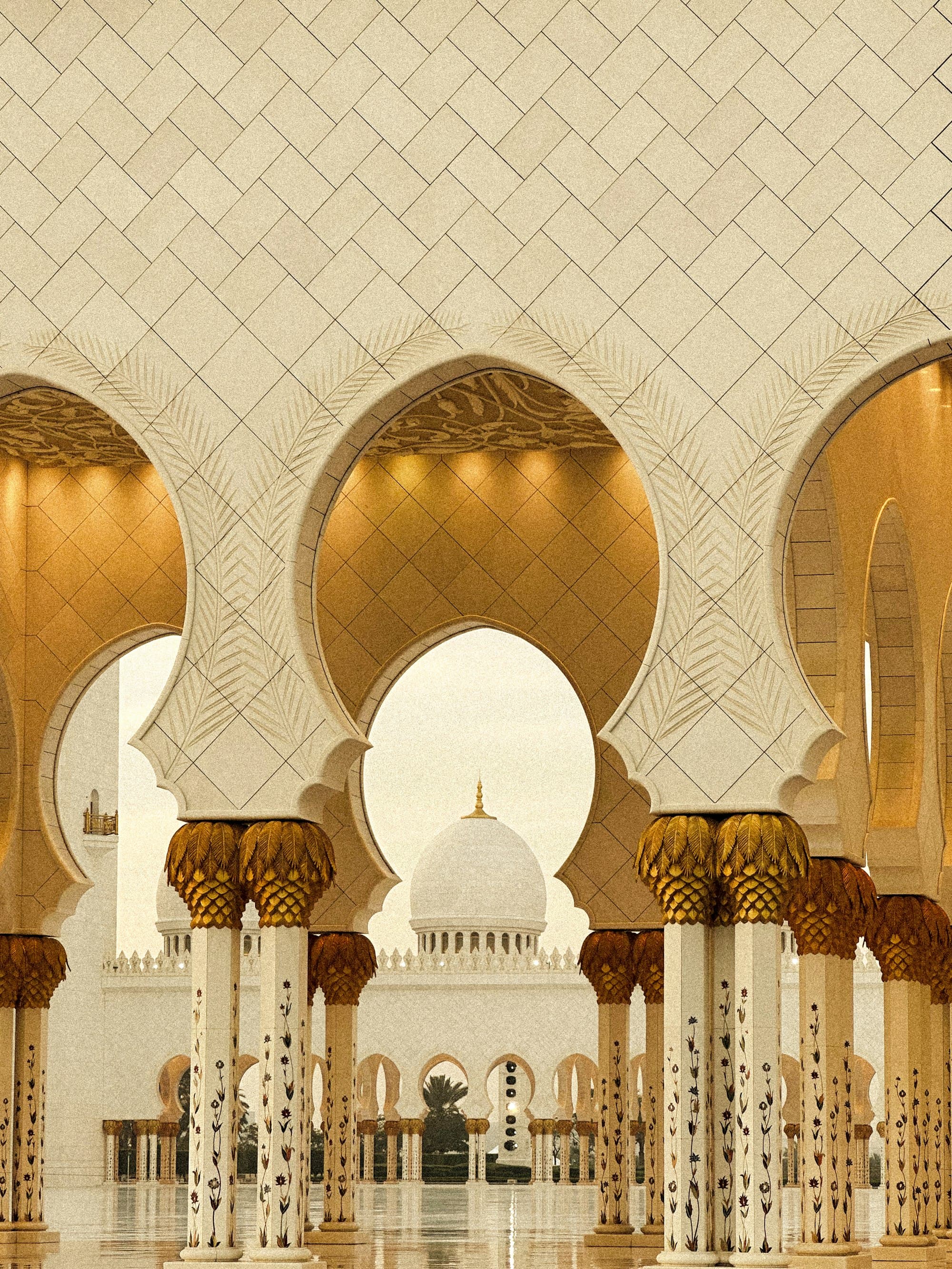 Light falling through the layered arches of a grand mosque interior